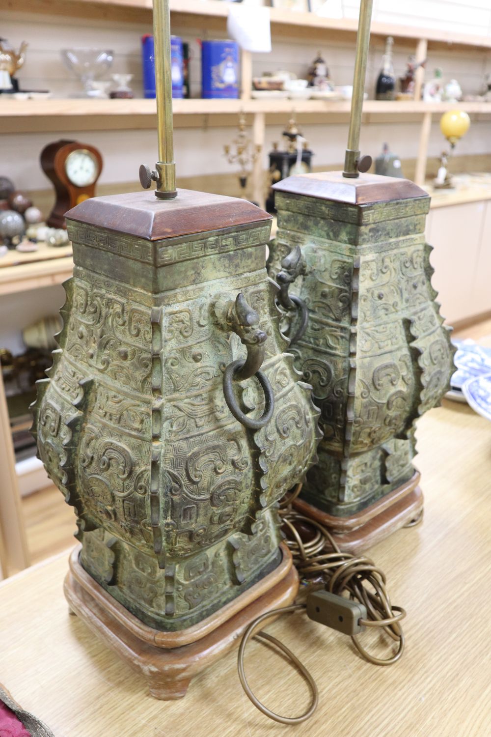 A pair of Chinese archaistic bronze lamps, height 47cm excl. light fitting